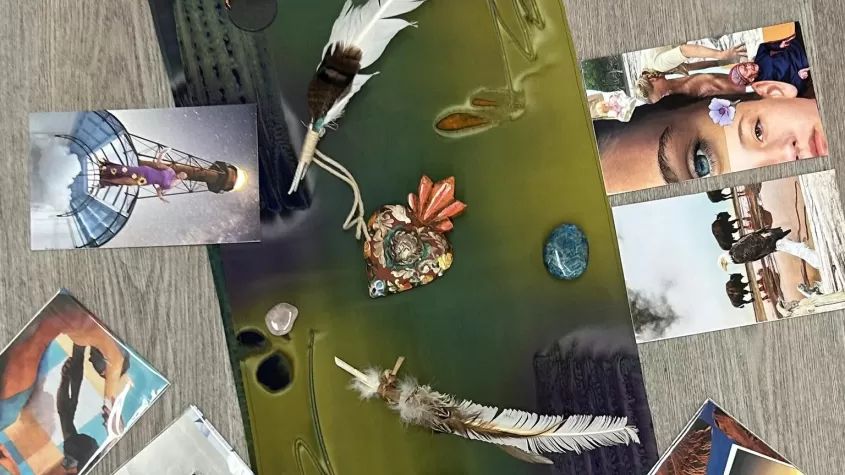 green mat on a wood floor with pictures from magazines around it