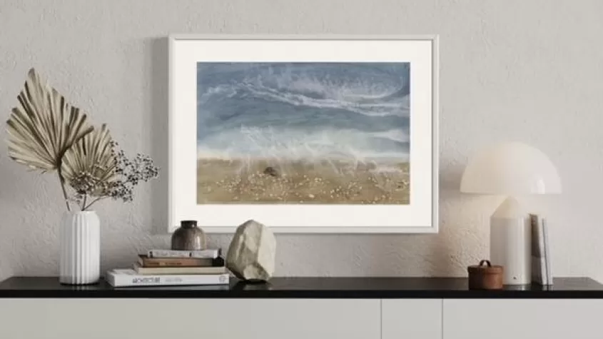picture of a styled sideboard with a beach scene resin "painting" on the wakll
