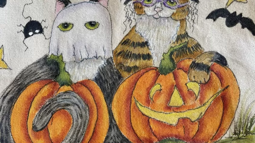 canvas bag painted with cartoon cats dressed as a ghost and a witch