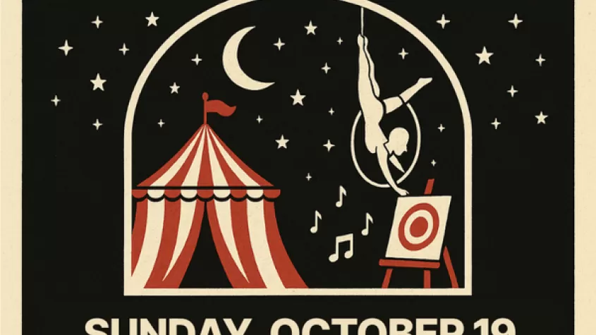 black background with stars and a snow globe with a circus set up in it