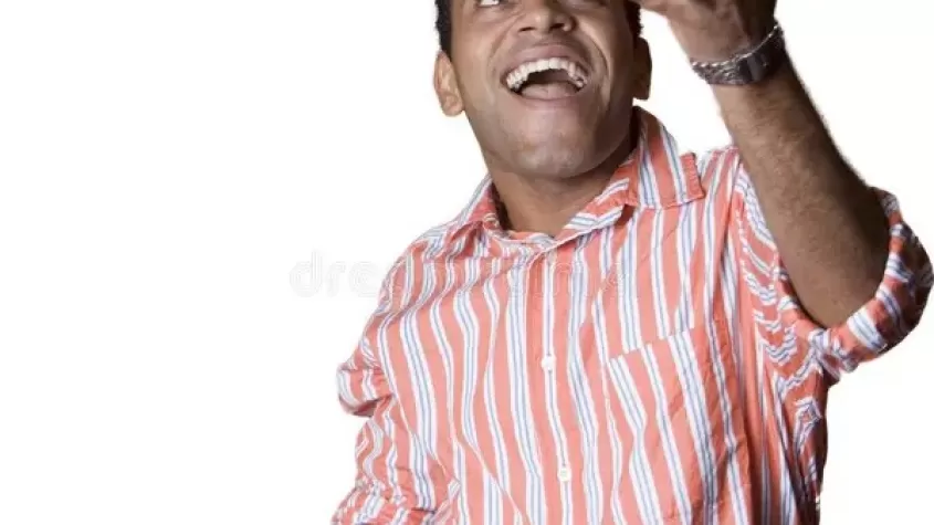image of man in an orange and whit striped shirt juggling four hacky sacks while smiling