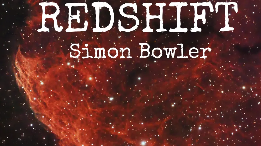 A black background with a red section of the cosmos prominently displayed