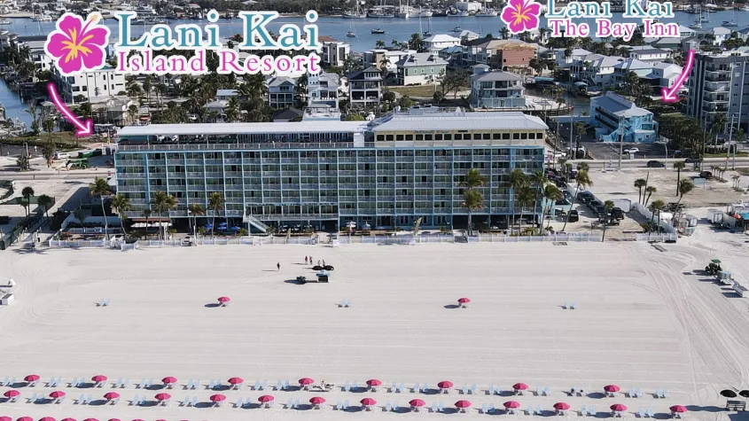beachfront hotel and chairs on the beach with a smaller hotel behind it and arrows pointing to each name of the hotels