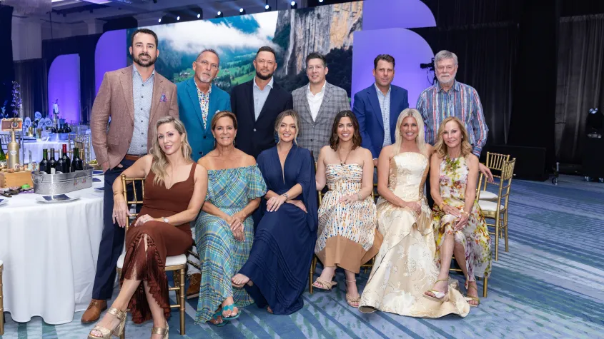 An event photo of a group of employees posing for a group photo.
