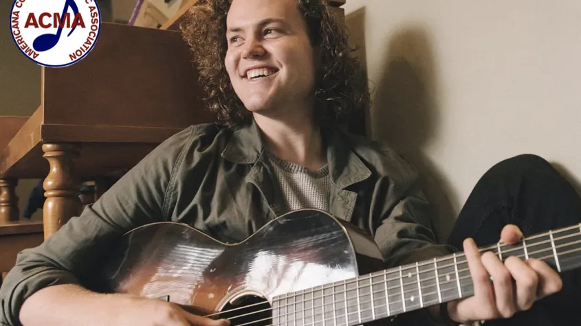 Performer Sam Robbins with guitar; ACMA logo in corner