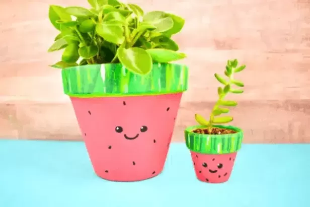 terracotta pots painted as smiling watermelons 
