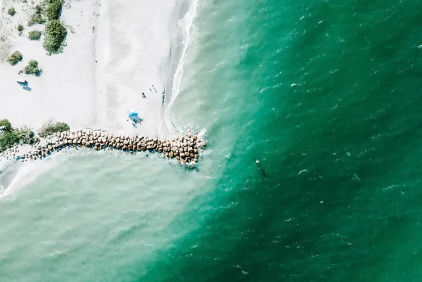 Aerial view of Blind Pass with white sand and turquoise water.
