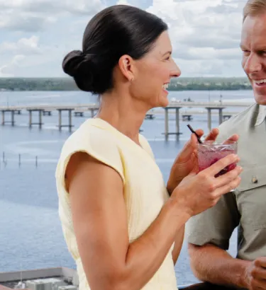 A couple enjoys cocktails at a rooftop bar in the culinary district