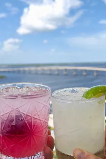 A couple holding two drinks in their hands