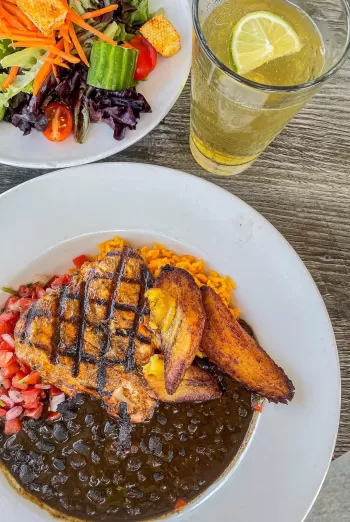 A table topped with plates of food and drinks