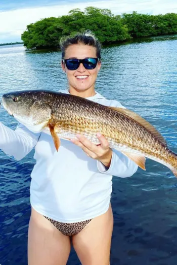 A woman shows off her prize catch.