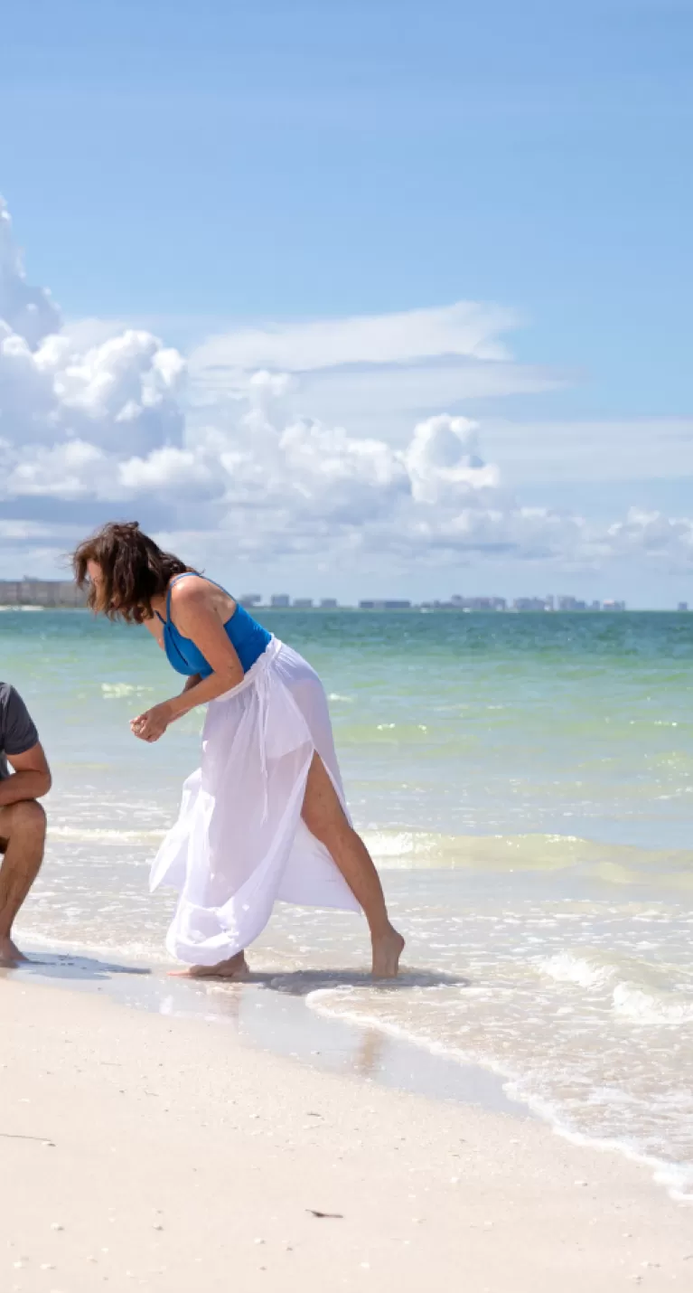 couple looking for shells at beach
