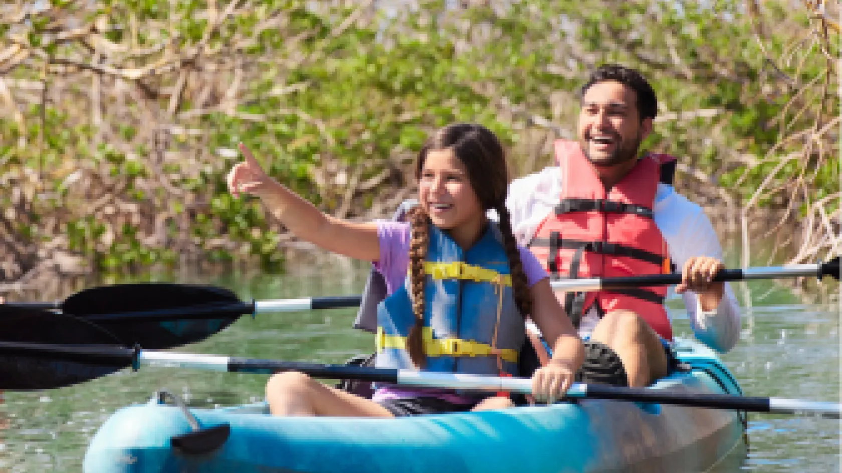 A father and daughter enjoys a paddle at Bunche Beach Preserve
