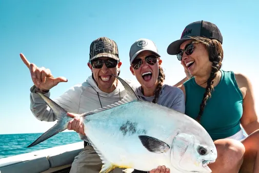 A group holds up the fish they caught