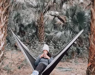 WomanDrinkCoffeeHammockTreesCaloosahatcheeRegionalPark_Alva_michieq1002_2021_01.jpg