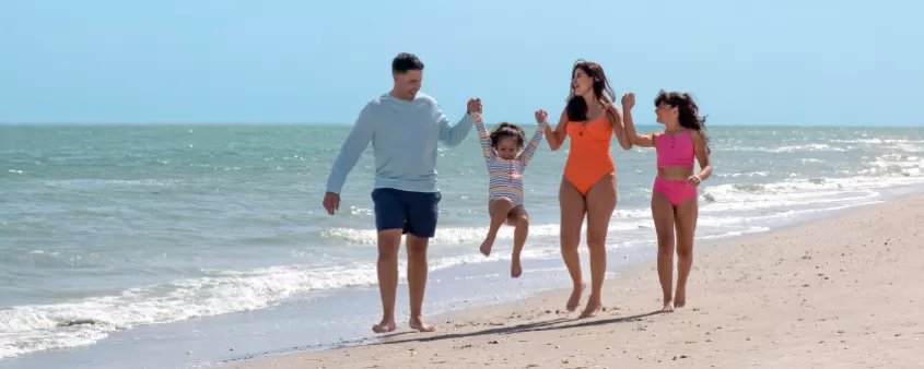 A family walks on the beach