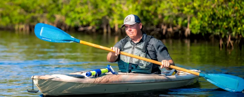 A man paddles through the mangroves in Cape Coral