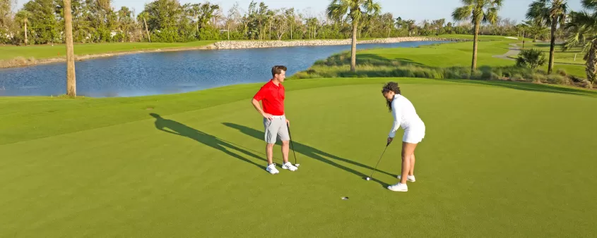 Man and woman playing golf at Bowman's Beach area