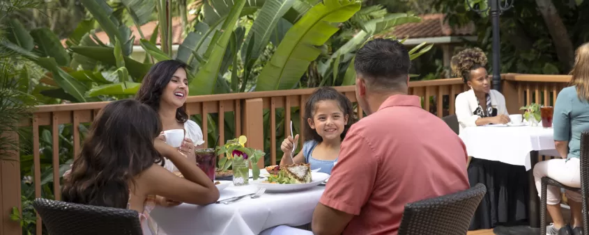 family dining on an outdoor deck