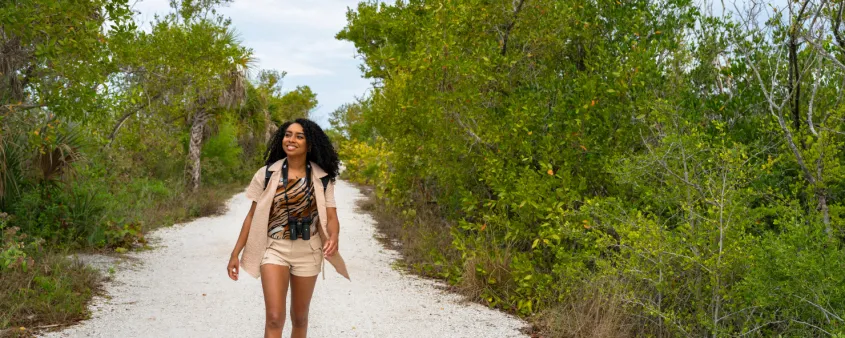 A teen hikes through a nature trail on Sanibel Island.