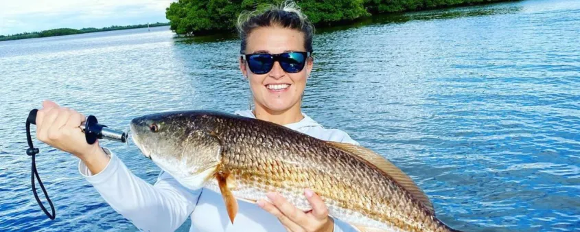 A woman shows off her catch