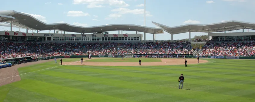 A baseball game is in progress at JetBlue Park in Fort Myers with fans filling the grandstands.