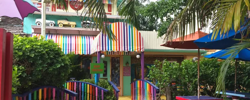 Brightly painted railings, walls and umbrellas fill the colorful outdoor entrance area of The Bubble Room on Captiva Island.