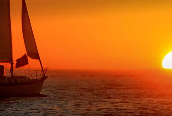 boat on the ocean with a sunset