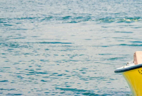 a boat captain drives his boat through open waters