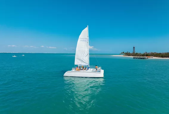 A small sailboat in the middle of a large body of water