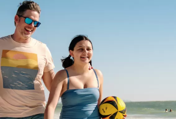A family walks along the beach
