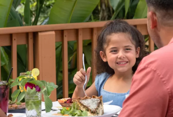A family enjoys dining at Harvest & Wisdom
