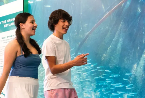 Two teens walk through a nature center