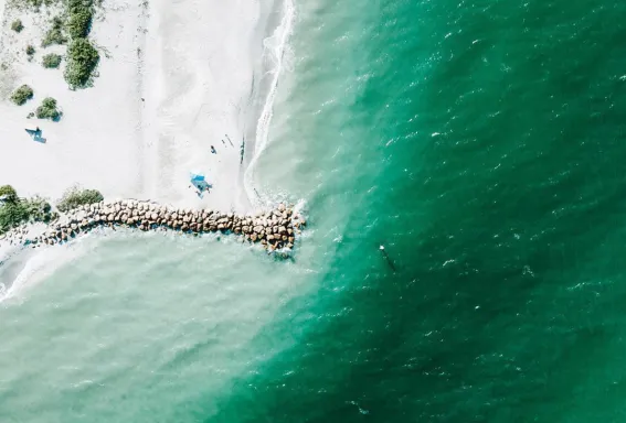 Aerial view of Blind Pass with white sand and turquoise water.