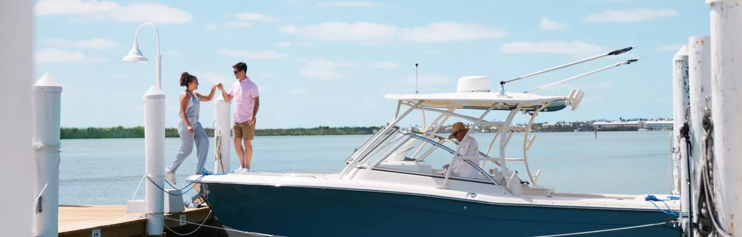 Couple exiting from boat on dock