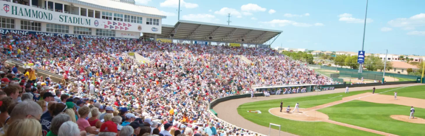 A crowd of people watching a baseball game