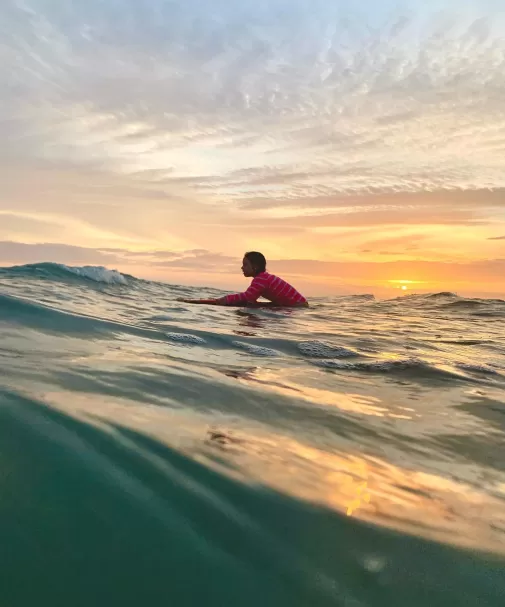 Man surfing at sunset