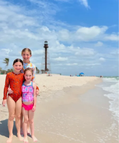 Three sisters pose for the camera on the beach on Sanibel Island