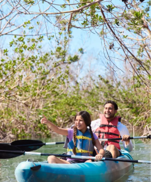 A father and daughter enjoys a paddle at Bunche Beach Preserve