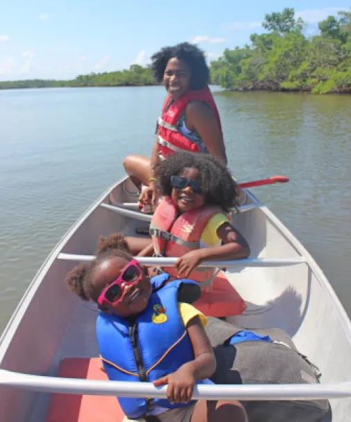 A mom and daughters enjoy canoeing on the Great Calusa Blueway Trail