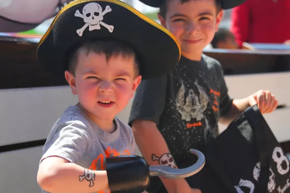 Two boys enjoy the pirate cruise.