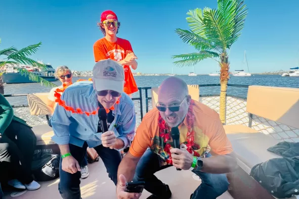 A family enjoys karaoke on a tiki cruise