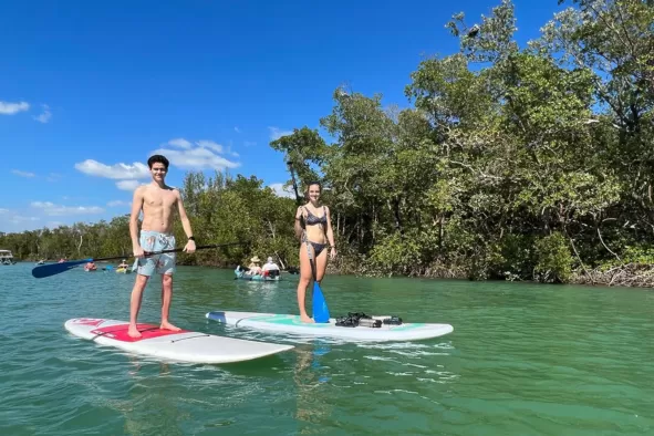 Siblings enjoy paddleboarding