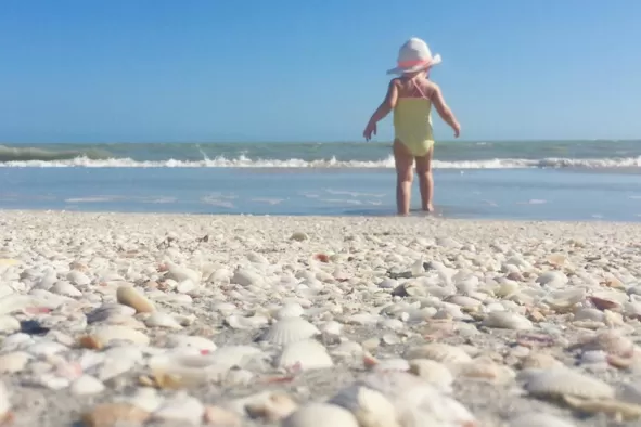 A little girl walks by the shore on Bowman's Beach.