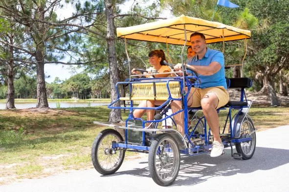 A family enjoys a surrey bike ride