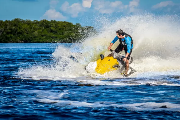 A man jumps the waves on a jet ski
