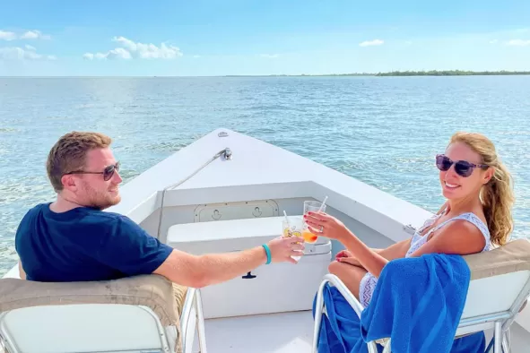A couple enjoys a boat ride across the waterways