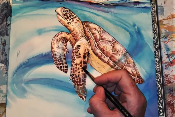 A person water color painting a sea turtle