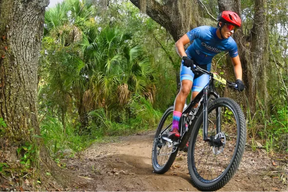 A man mountain bikes at Caloosahatchee Regional Park
