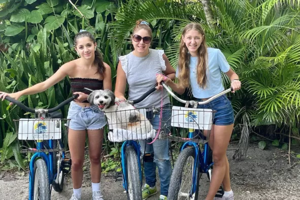A mom and her two teen daughters enjoy a bike ride